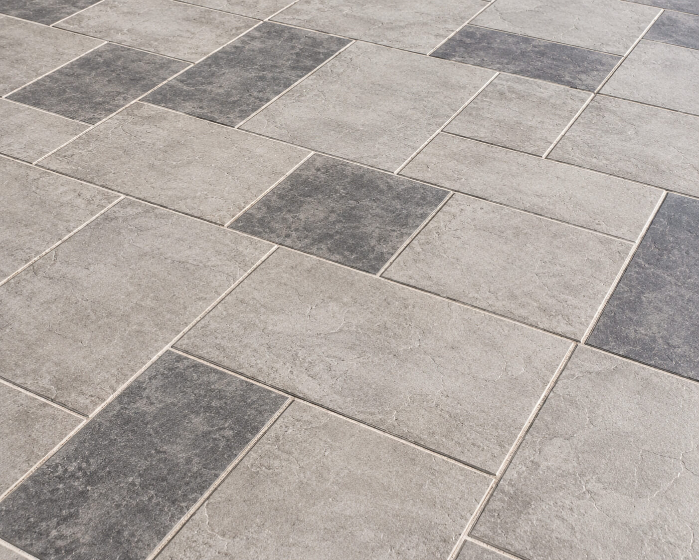 Gray modular tile patio and walkway overlay in a grid pattern
