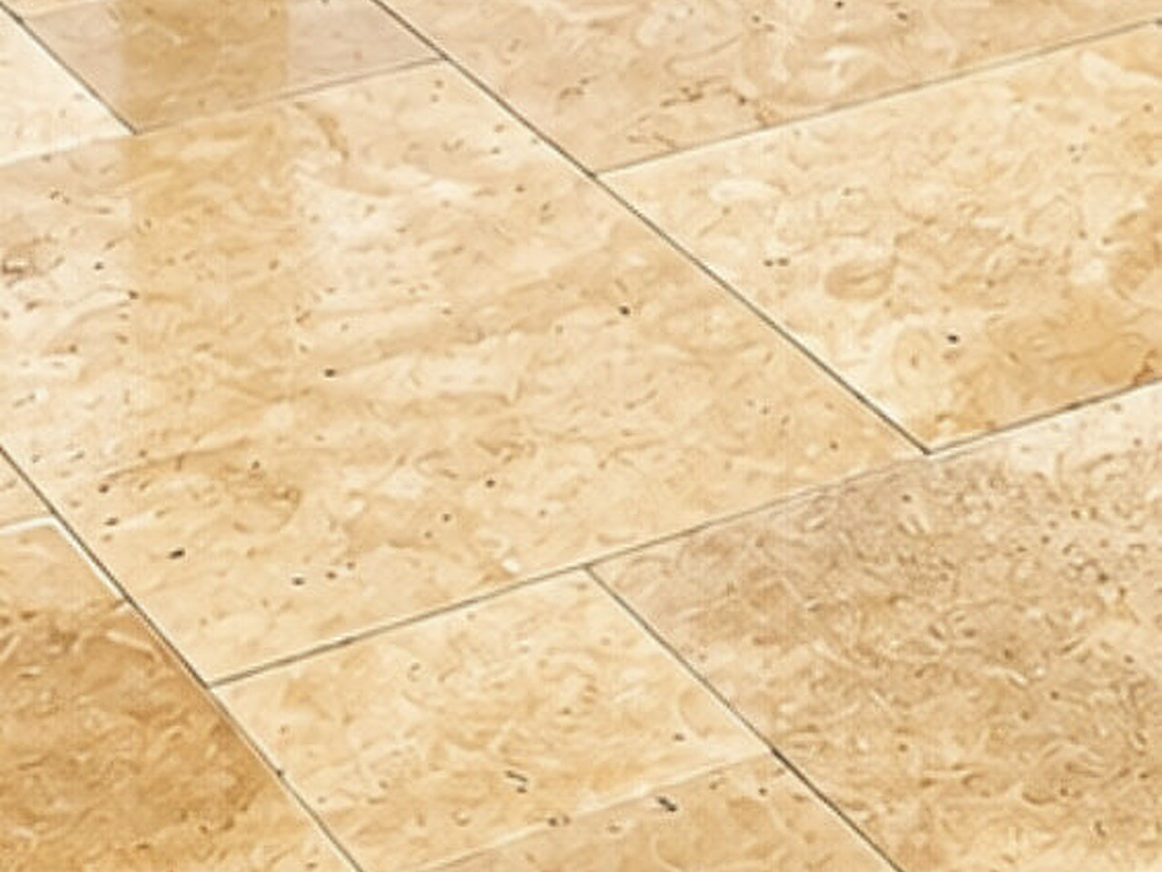 Close-up of ivory travertine pavers set in French pattern in Greenacres