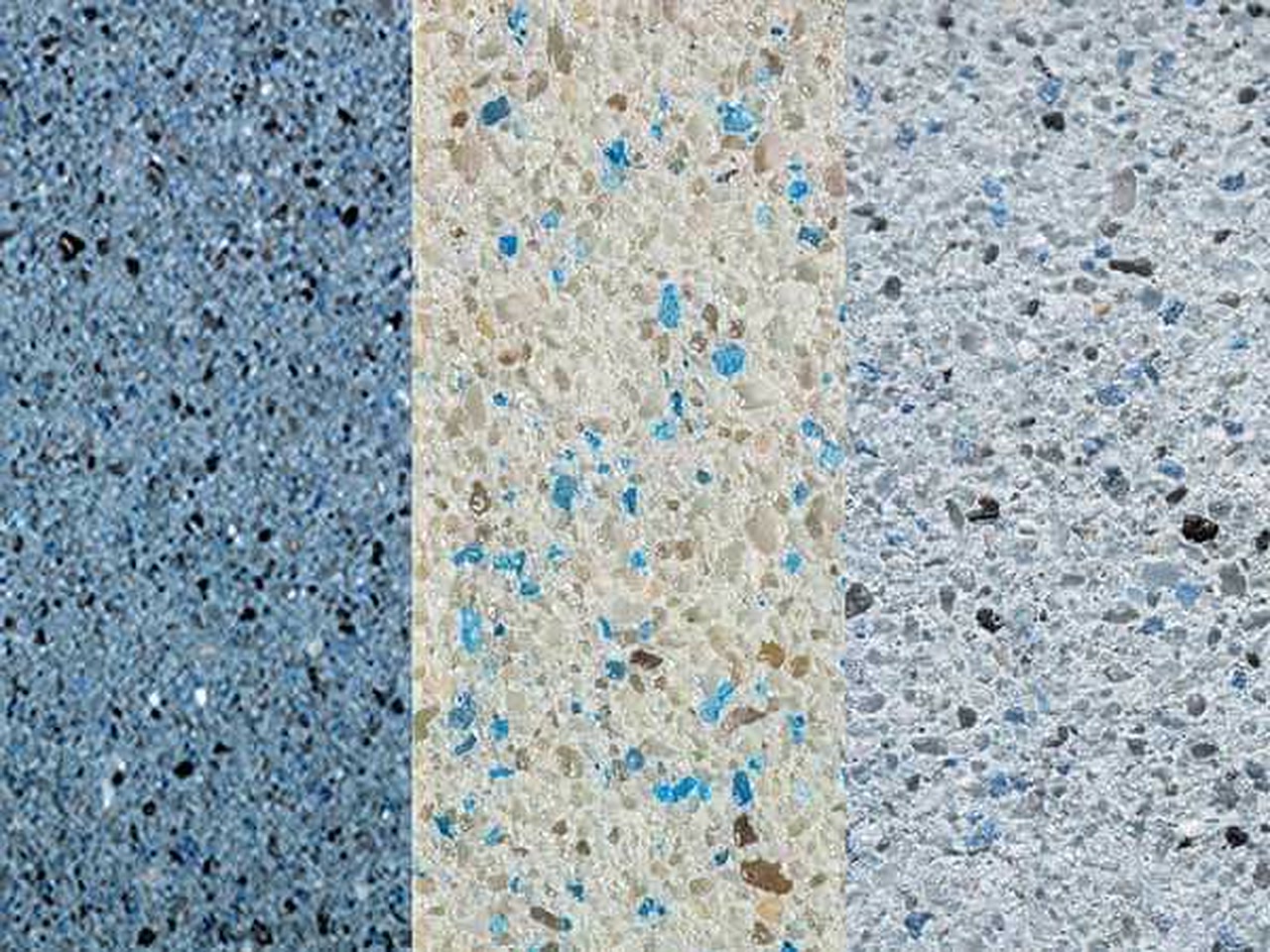 Three gem aggregate pool finish samples side by side, from steel blue to cream and pale gray with blue glass flecks, Deerfield Beach